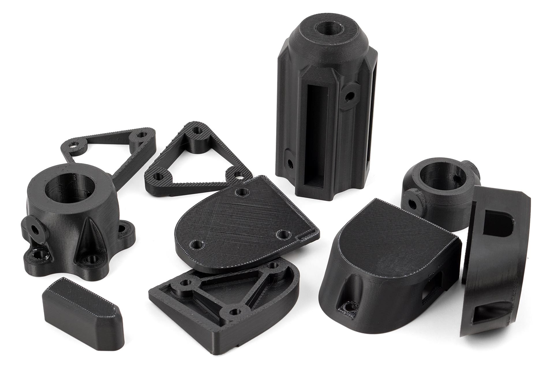 Black ABS 3D prints of various parts.