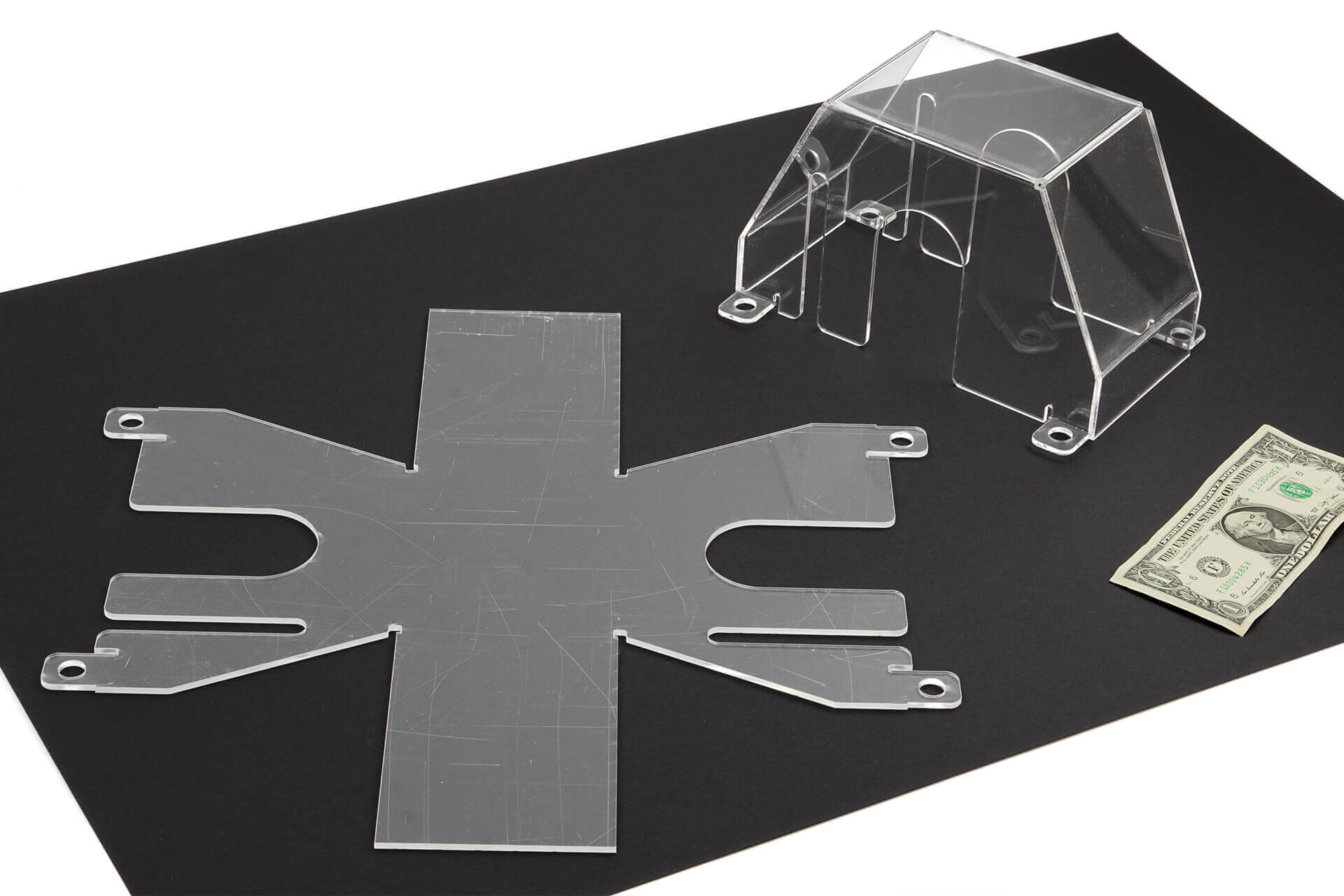 A bent acrylic form, for covering a power switch.