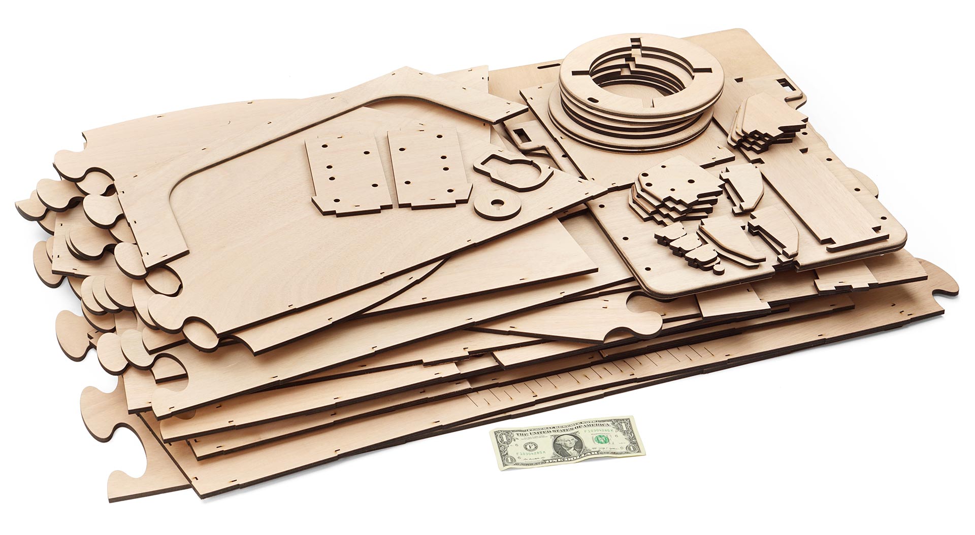 A stack of laser cut quarter-inch plywood for a mini boat.