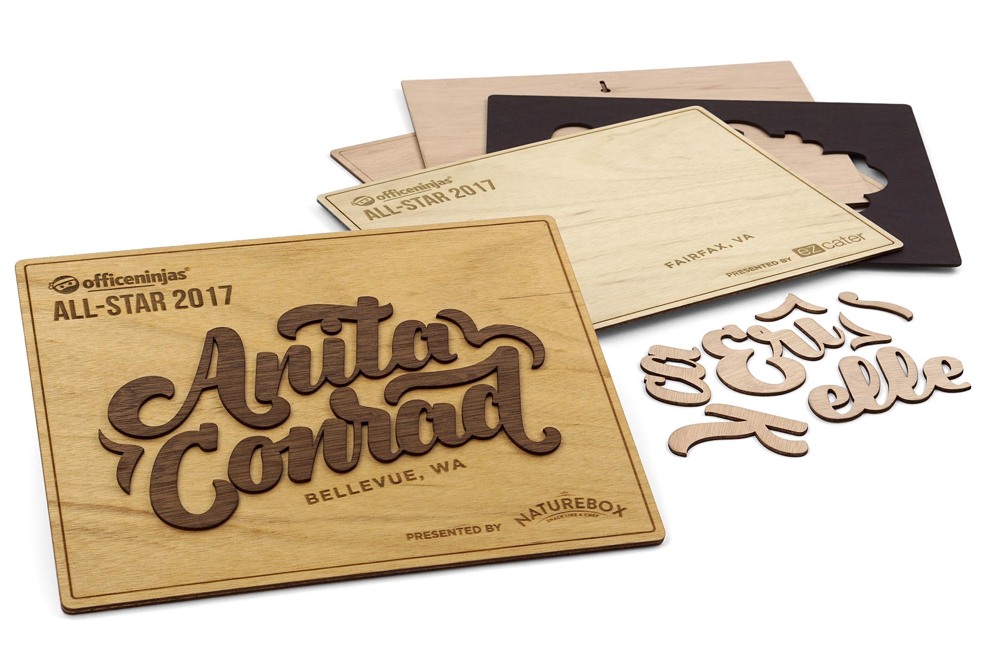 A fancy wooden wooden award with dark stained wood on light colored wood.