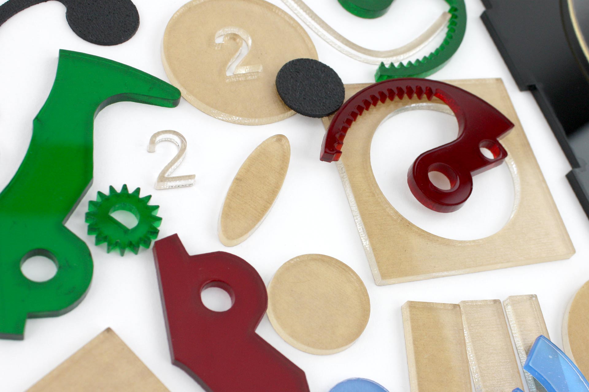 A colorful, cropped shot of various mechanical looking acrylic parts.