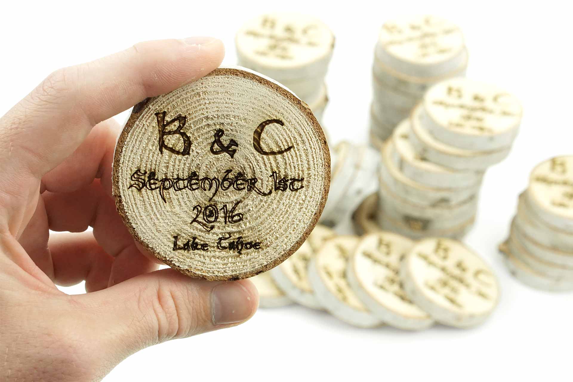 Laser etched wooden coasters cut from a tree branch.