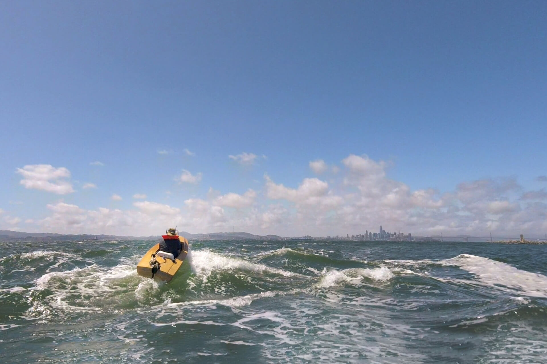 Dylan pushing his mini boat to the limits in the San Francisco Bay chop.