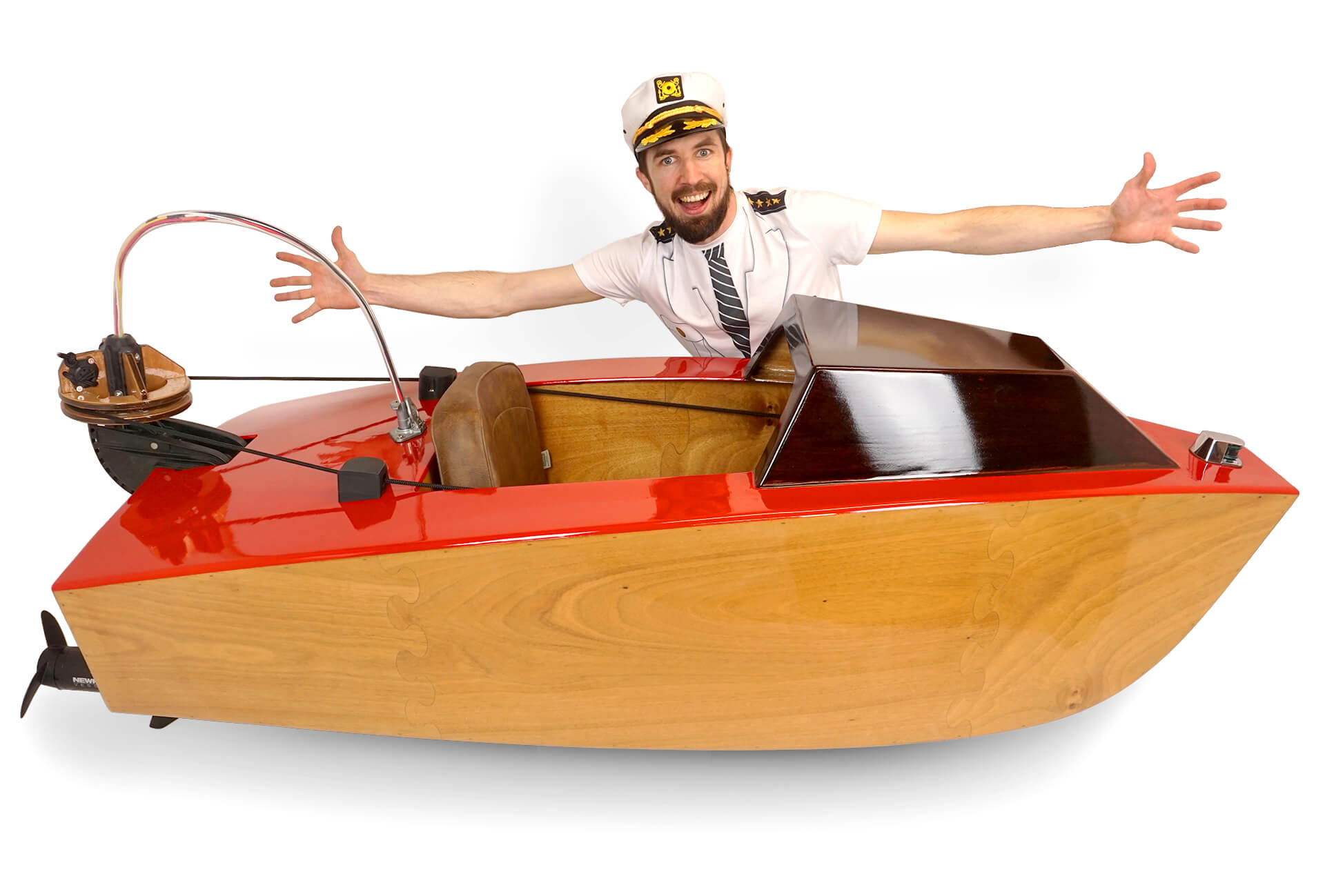 A hero shot of the laser cut mini boat with the creator behind it.